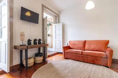 a living room with a couch and a rug at Bonjardim Deluxe Loft in Porto