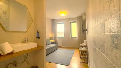 a bedroom with a bed with a painting on the wall at ALIBI by YoursPorto in Porto