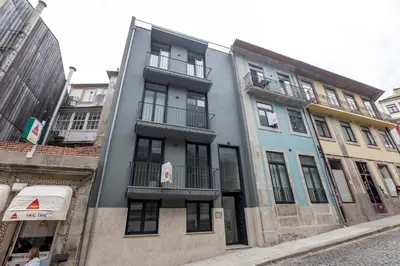 a tall building with balconies on a city street at Downtown Wonder Flat w/ AC by LovelyStay in Porto