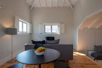 a living room with a table and a couch at Oporto Rooftop Studio by Vacationy in Porto