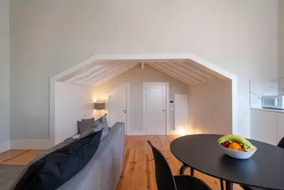 a living room with a table with a bowl of fruit on it at Oporto Rooftop Studio by Vacationy in Porto