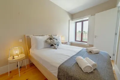 a bedroom with a large bed with towels on it at Boavista Premium Apartments by Vacationy in Porto