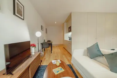 a living room with a couch and a television at Legacy Oporto Premium Apartments by Vacationy in Porto