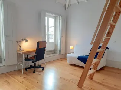 a bedroom with a desk and a bed and a ladder at Porto Vista by Flat in Porto in Porto