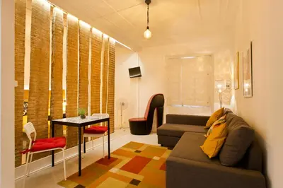 a living room with a couch and a table at Oporto Blue Vitória - Lovely Citycenter Studio in Porto