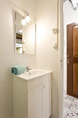 a white bathroom with a sink and a mirror at Oporto Blue Vitória - Lovely Citycenter Studio in Porto