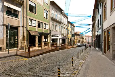 a cobblestone street in a city with buildings at Oporto Blue Vitória - Lovely Citycenter Studio in Porto