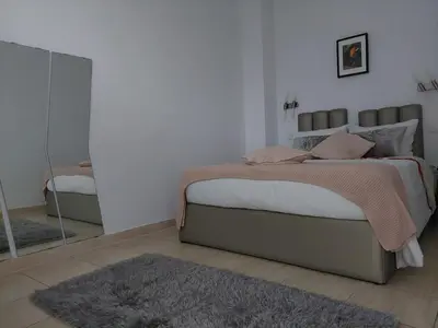 a bedroom with a large bed and a mirror at charming loft in Porto in Porto