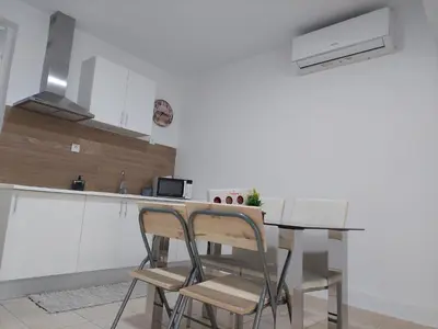 a kitchen with a table and chairs in a room at charming loft in Porto in Porto