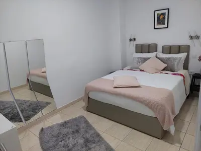 a bedroom with a large bed and a mirror at charming loft in Porto in Porto