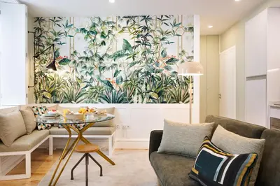 a living room with a wall mural of plants at Away to Enjoy Apartment - hapiness has a place in Porto