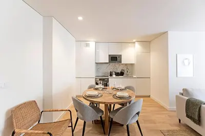 a kitchen and dining room with a table and chairs at Paraíso -1B w/ AC & Patio by LovelyStay in Porto