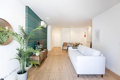 a living room with a white couch and a table at Paraíso -1B w/ AC & Patio by LovelyStay in Porto