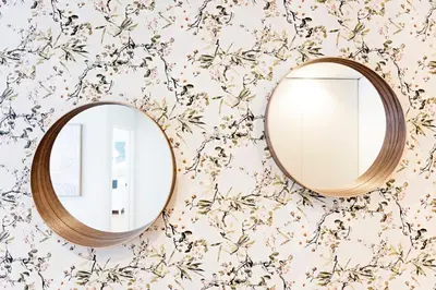 a mirror on a wall with floral wallpaper at NEW Cozy and Modern Apartment in the heart of Porto in Porto