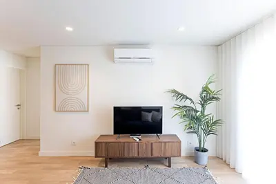 a living room with a tv and a coffee table at NEW Cozy and Modern Apartment in the heart of Porto in Porto
