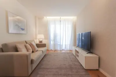 a living room with a couch and a flat screen tv at HM - Casa Ghiselini Porto 215 in Porto