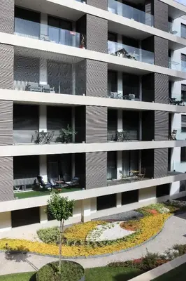 an apartment building with a garden in front of it at HM - Casa Ghiselini Porto 215 in Porto