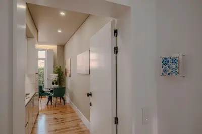 a hallway with a door leading to a dining room at Green Garden Luxury House w/ AC, Metro & Downtown in Porto