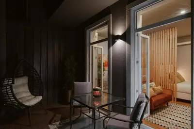 a living room with a table and a chair at Green Garden Luxury House w/ AC, Metro & Downtown in Porto