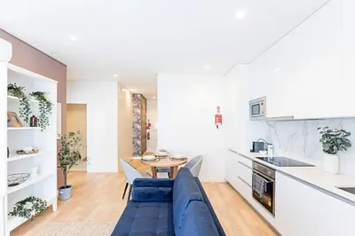 a living room with a blue couch and a table at Paraíso 1H w/ AC by LovelyStay in Porto