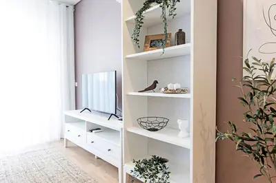 a room with white shelves with a tv at Paraíso 1H w/ AC by LovelyStay in Porto