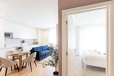 a living room with a blue couch and a table at Paraíso 1H w/ AC by LovelyStay in Porto