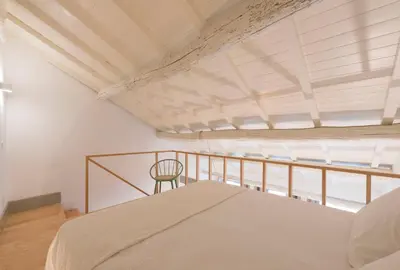 a bedroom with a bed and a chair at VIVA Old Street Homes in Porto