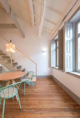 a room with stairs and a table and chairs at VIVA Old Street Homes in Porto