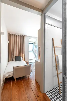 a bedroom with a bed and a walk in closet at VIVA Old Street Homes in Porto