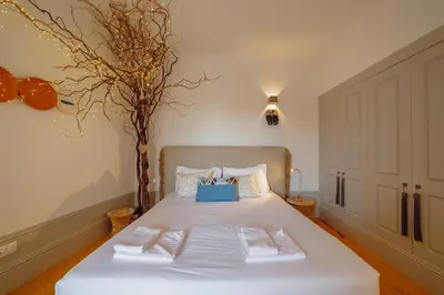 a bedroom with a white bed with two pillows at Downtown Modern Studio With Terrace by Vacationy in Porto