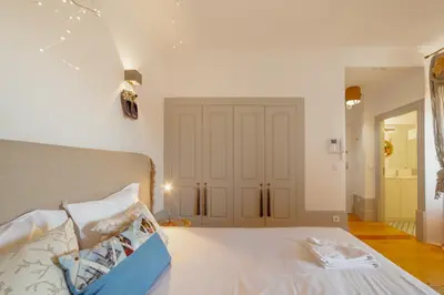 a bedroom with a white bed and a door at Downtown Modern Studio With Terrace by Vacationy in Porto