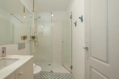 a bathroom with a shower and a toilet and a sink at Downtown Modern Studio With Terrace by Vacationy in Porto