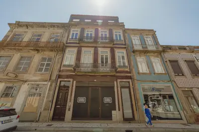 a woman standing in front of a building at Downtown Modern Studio With Terrace by Vacationy in Porto