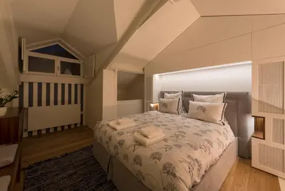 a bedroom with a large bed with pillows at Flores City Retreat in Porto