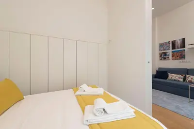 a bedroom with a bed with towels on it at Santo António Oporto House in Porto