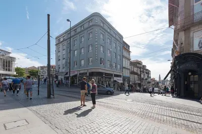 a group of people walking down a city street at Santo António Oporto House in Porto