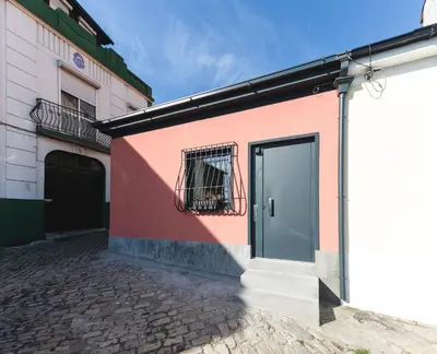 a pink building with a door and a window at Alegria Cool House in Porto