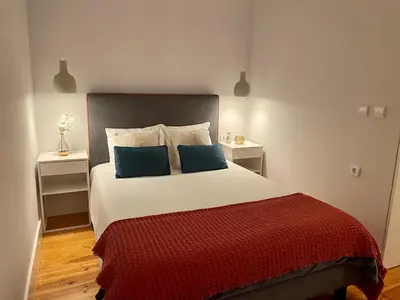 a bedroom with a large bed with two night stands at Santo António Elegant Flat in Porto
