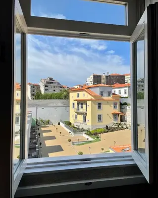 an open window with a view of a building at Santo António Elegant Flat in Porto