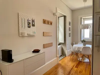 a living room with a table and a chair at Santo António Elegant Flat in Porto