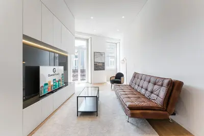 a living room with a couch and a television at GuestReady - Casas de Mompilher in Porto