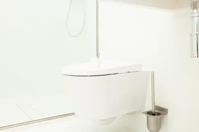 a white bathroom with a white sink in a room at Apartamentos da Capela in Porto