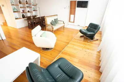 a living room with a couch and chairs and a table at Apartamentos da Capela in Porto