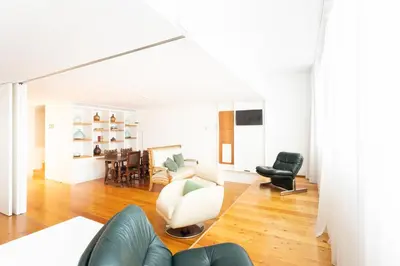 a living room with a couch and a chair at Apartamentos da Capela in Porto
