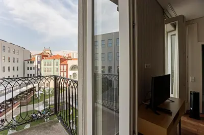 a balcony with a view of a city at Palácio das Cardosas Studio by LovelyStay in Porto
