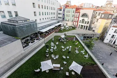 an overhead view of a courtyard with tables and umbrellas at Palácio das Cardosas Studio by LovelyStay in Porto
