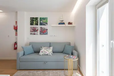 a living room with a couch and a table at 31 de Janeiro Oporto House in Porto
