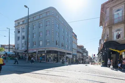 a building on a city street with people walking around at 31 de Janeiro Oporto House in Porto