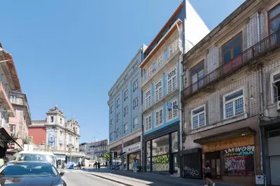 a city street with buildings and a car parked on the street at 31 de Janeiro Oporto House in Porto