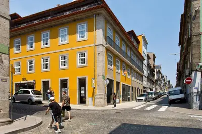 a yellow building on the side of a street at BOUTIQUE Rentals-THE ALMA Apt w/ balcony in Porto